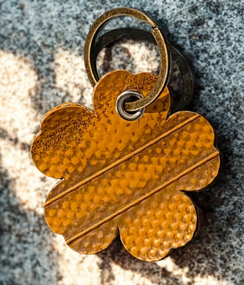 Flower-shaped keyring is made from genuine recycled fire hose